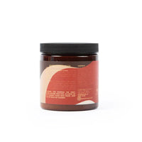 Braunes Haarpflege-Creme-Behälter mit schwarzem Deckel, Rückseite mit Inhaltsstoffen.