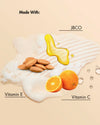Haarpflege Textur mit Mandeln, Orangen, Öl, Vitamin E und Vitamin C auf beigem Hintergrund